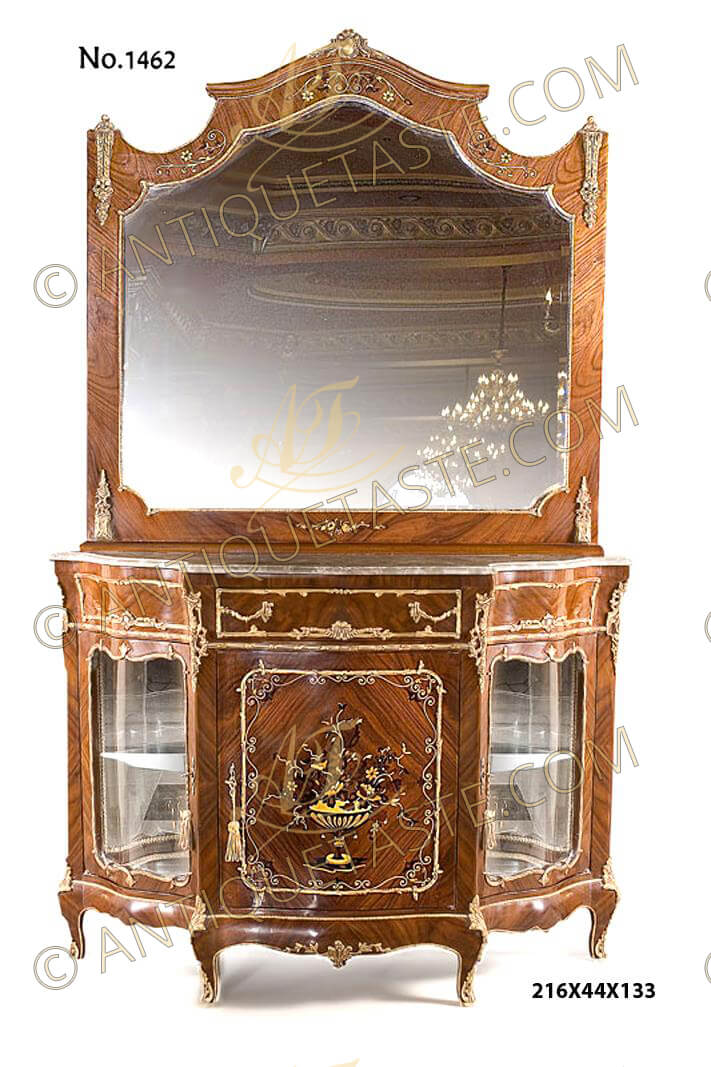 A fabulous French Transitional style ormolu-mounted veneer and marquetry inlaid entrance console cabinet with a matching mirror after the model by Henri Picard (1840-1890), The domed top scalloped shaped mirror frame crested with central ormolu cabuson mount, cornered on top and bottom by a fine chiseled foliate ormolu chutes, the top and bottom frieze are inlaid with delicate foliage marquetry patterns. The internal mirror border shaped and bordered in ormolu C scrolls strips, Resting on a serpentine shaped cabinet marble top above the apron with central drawer bordered with foliate scrolled ormolu trim and foliate handles, flanked by exquisite pierced acanthus ormolu chutes, the sides has the same ormolu trim as well,  The lower part has three doors, the central door has an inset panel with high quality exoticwood floral detailed marquetry with scrolled marquetry border within a leafy ormolu border and ormolu keyhole escutcheon, the mirrored back two doors on each side with one tier and glass front within a scalloped foliate border and ormolu keyhole escutcheons, all above a scalloped shaped apron, The cabinet is raised on short cabriole legs ornamented with delicate chiseled gilt ormolu acanthus mount elongated with ormolu trim to the pierced foliate ormolu sabots, the contour of the apron decorated with an ormolu strip and foliage ormolu mounts to the central part